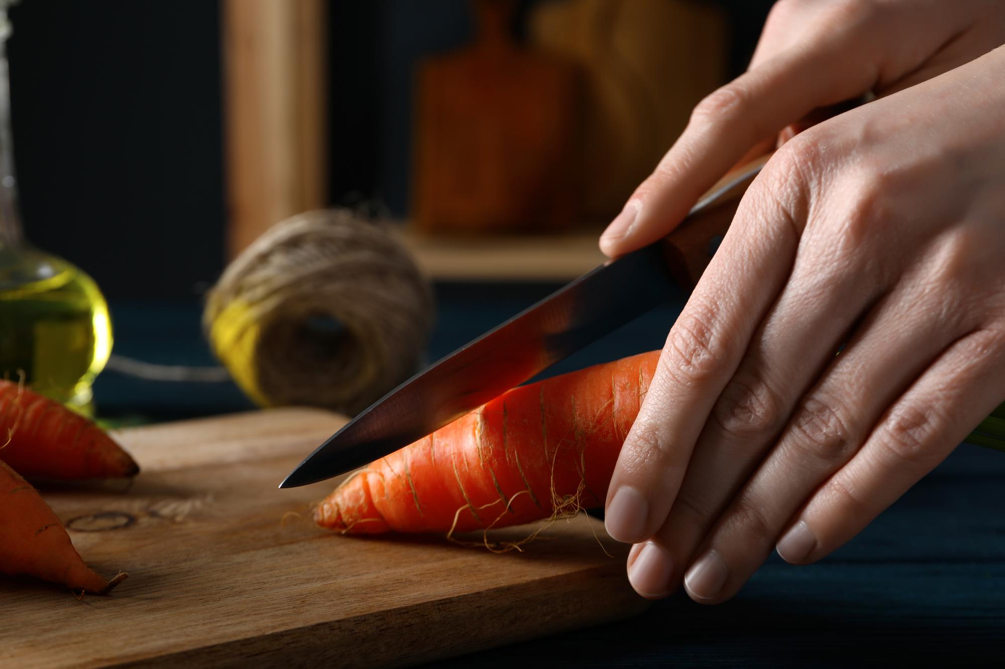 Hands learning knife skills in workshop